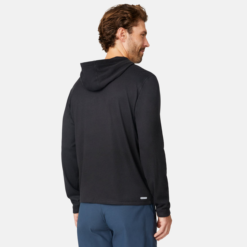 [Matt is 6'2" wearing size M.] Free Country men’s dark-colored hooded long-sleeve shirt with relaxed fit—styled with blue pants against a plain white background for a casual, comfort-forward look.