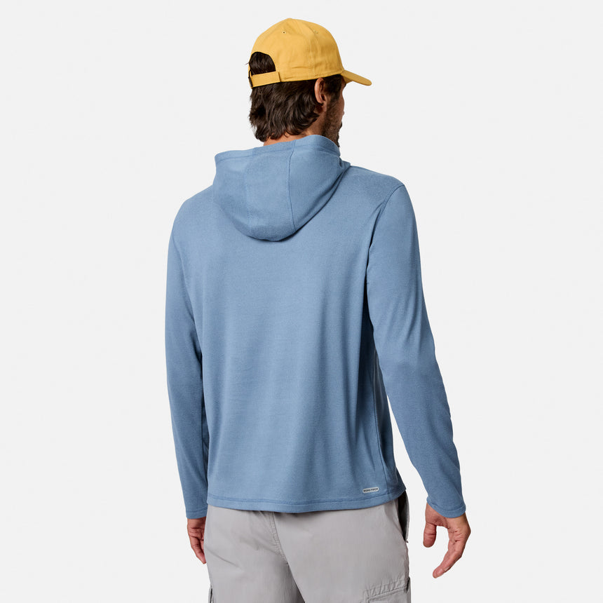 [Model is wearing size M.] A man wearing a light blue hooded long-sleeve shirt, shown from the back, paired with a yellow baseball cap and light gray pants, against a plain light gray background.
