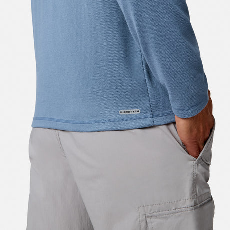 [Model is wearing size M.] Close-up of a person wearing a light blue long-sleeve performance top and light gray cargo pants, with the hand in the pants pocket and a small MICRO-TECH label visible near the hem.