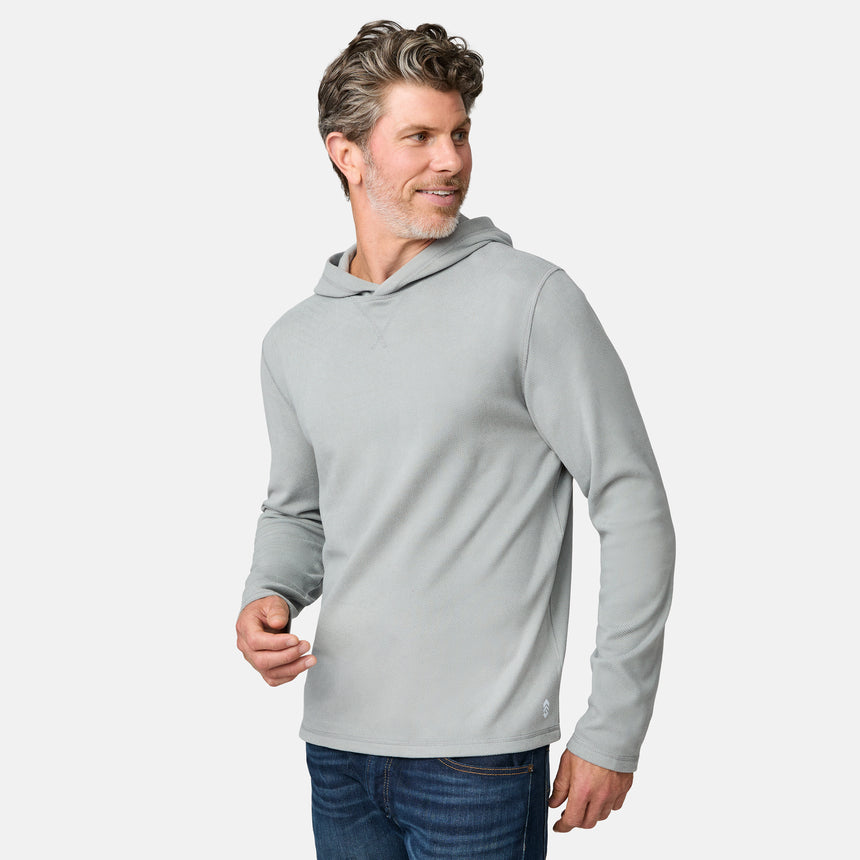 [Kolby is 6'2" wearing size M.] Free Country men’s light gray hooded long-sleeve shirt with subtle textured fabric—styled with dark blue jeans for a casual, comfort-forward look.