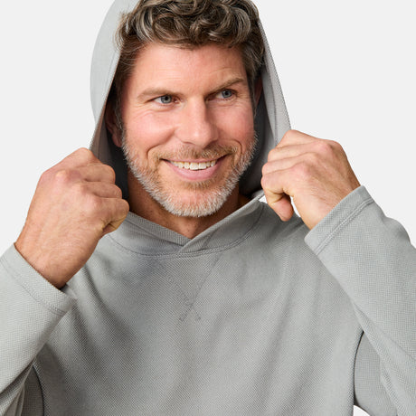[Kolby is 6'2" wearing size M.] Free Country men’s light gray hooded long-sleeve shirt with subtle textured fabric—styled with dark blue jeans for a casual, comfort-forward look.