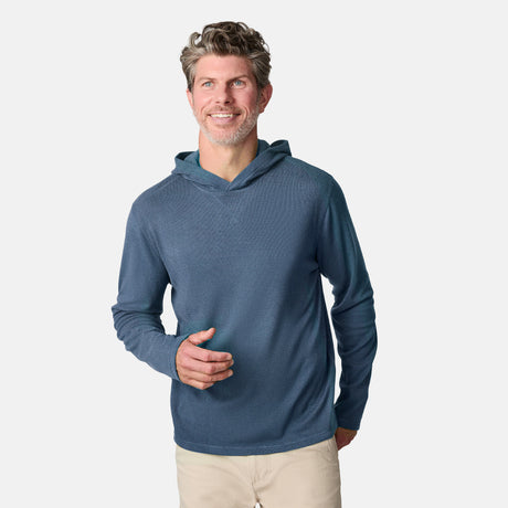 [Kolby is 6'2" wearing size M.] Free Country men’s blue textured lightweight hoodie with long sleeves and subtle pattern—paired with beige pants for a relaxed, transitional-weather look.