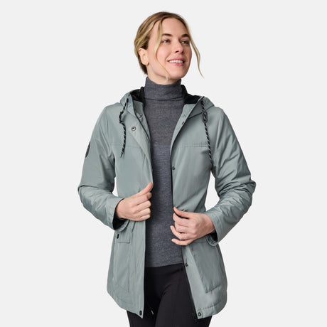 [CJ is 5'10" wearing size S.] Women’s light green hooded rain jacket with front zip closure, flap pockets with button accents, black hood drawstrings, and a sleeve patch—layered over a dark gray turtleneck and styled with black pants for a sleek, weather-ready look.
