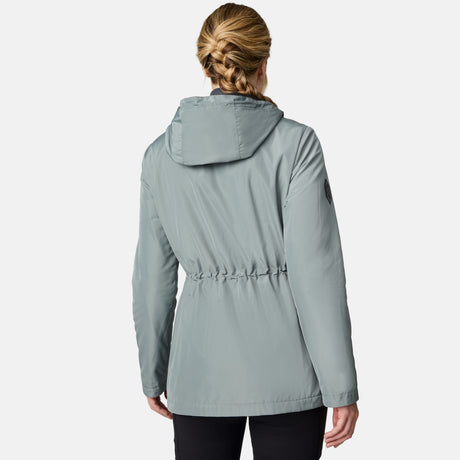[CJ is 5'10" wearing size S.] Women’s light green hooded rain jacket with front zip closure, flap pockets with button accents, black hood drawstrings, and a sleeve patch—layered over a dark gray turtleneck and styled with black pants for a sleek, weather-ready look.