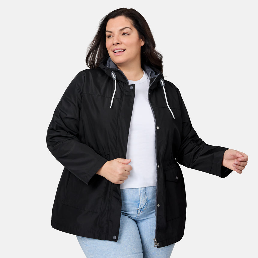 Woman wearing a black jacket over a white shirt and blue jeans on a white background