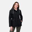 A woman with long brown hair models the Free Country Women's Rain Away Anorak Rain Jacket, featuring water resistance, an adjustable hood, and pockets, posing with one hand in her pocket against a light gray background.