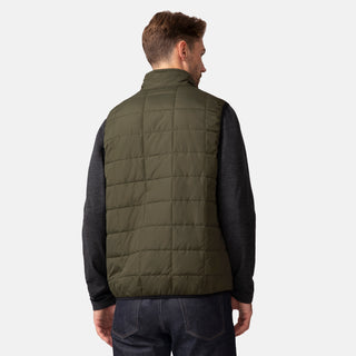 [Matt is 6'2" wearing a size Medium.] Man wearing the Free Country Men's FreeCycle® Stimson Puffer Vest in green, featuring quilted design, REPREVE® poly fill, and a vertical zip, layered over a black long-sleeve shirt with dark jeans.