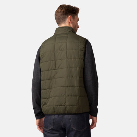 [Matt is 6'2" wearing a size Medium.] Man wearing the Free Country Men's FreeCycle® Stimson Puffer Vest in green, featuring quilted design, REPREVE® poly fill, and a vertical zip, layered over a black long-sleeve shirt with dark jeans.
