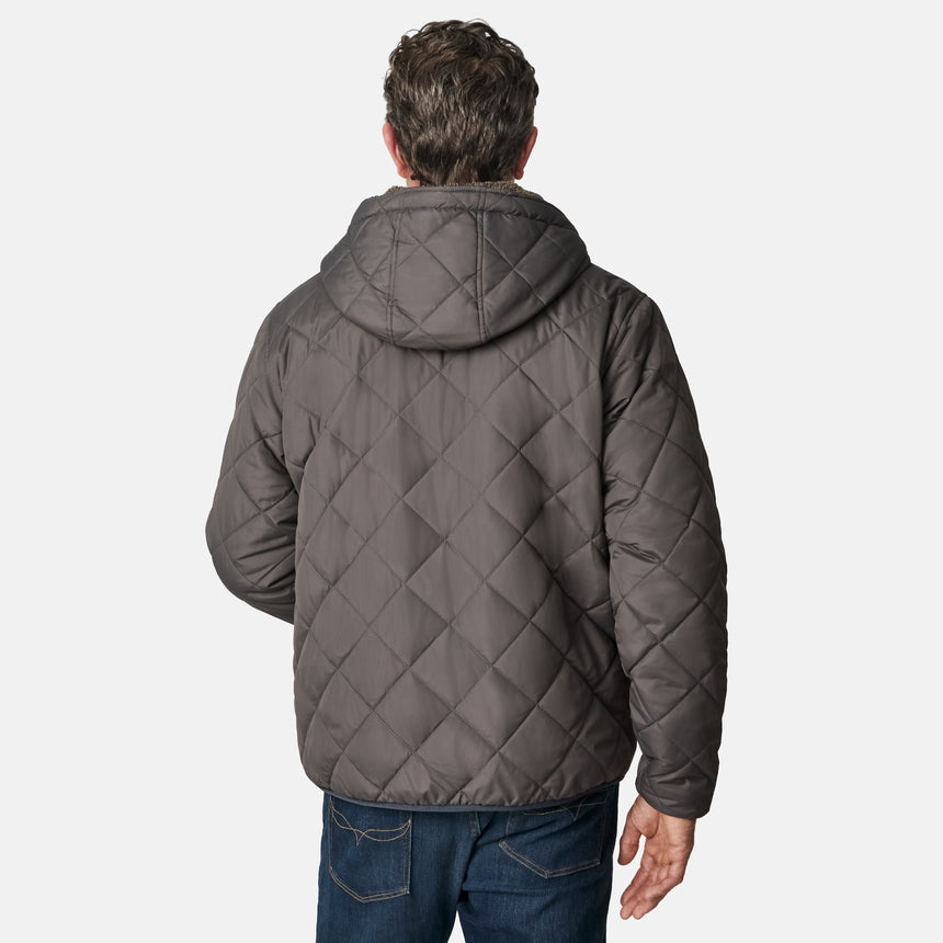 [Kolby is 6'2" wearing size M.] Men’s Free Country grey quilted hooded jacket with full-zip closure, adjustable drawstring hood, and dual hand pockets—reversible to a plush sherpa lining for enhanced warmth and cozy comfort. Styled over a dark crewneck and jeans for an effortlessly rugged, cold-weather vibe.