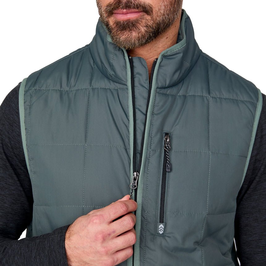 [Justin is 6'1" wearing size M.] Man wearing a green puffer vest with a brand logo on a white background