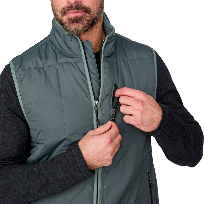 [Justin is 6'1" wearing size M.] Man wearing a green puffer vest with a white background