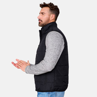 [Justin is 6'1" wearing size M.] Men’s Free Country black quilted vest with zip-front closure and stand collar—layered over a gray long-sleeve shirt and blue jeans. Designed for lightweight warmth and styled for transitional weather versatility.