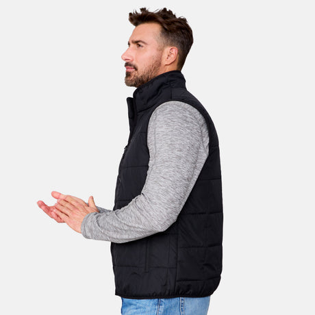 [Justin is 6'1" wearing size M.] Men’s Free Country black quilted vest with zip-front closure and stand collar—layered over a gray long-sleeve shirt and blue jeans. Designed for lightweight warmth and styled for transitional weather versatility.