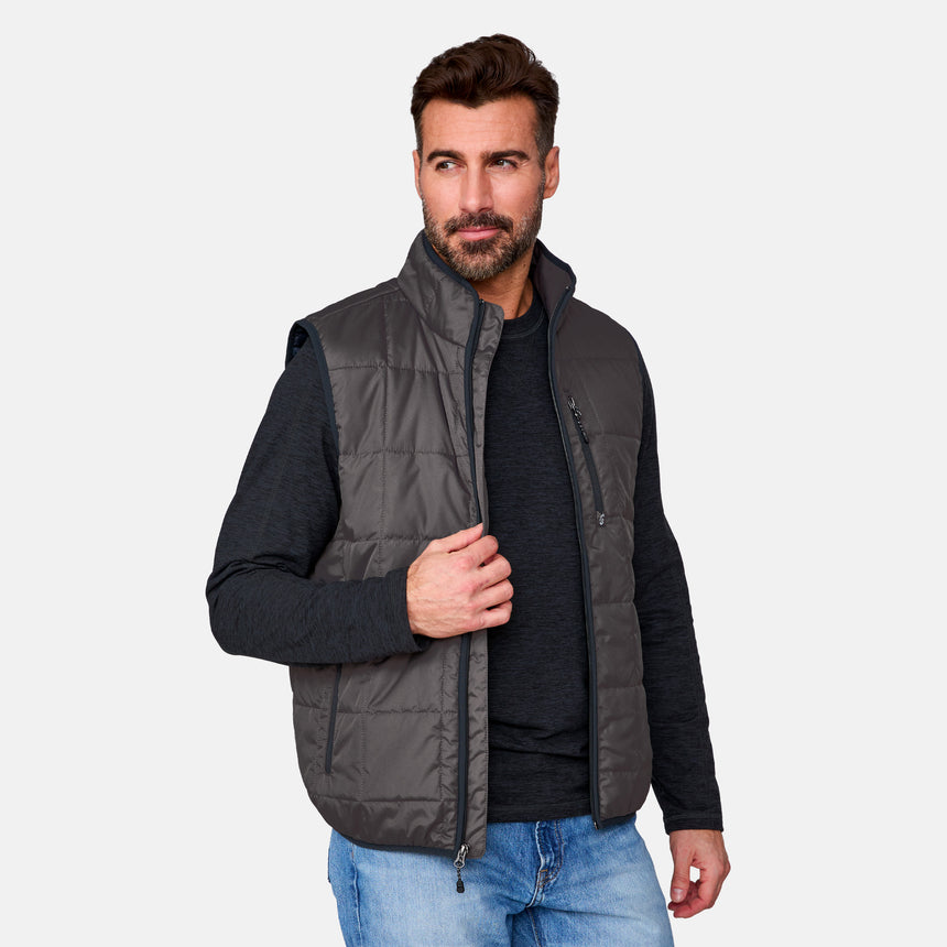 [Justin is 6'1" wearing size M.] Man wearing a gray quilted vest over a black shirt with a light gray background