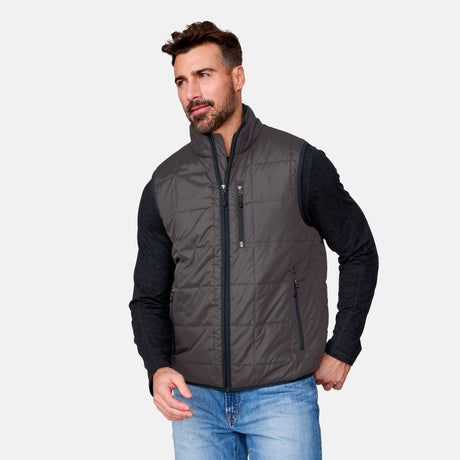 [Justin is 6'1" wearing size M.] Man wearing a gray quilted vest over a black long-sleeve shirt on a light gray background