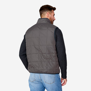 [Justin is 6'1" wearing size M.] Man wearing a gray puffer vest over a black long-sleeve shirt on a white background