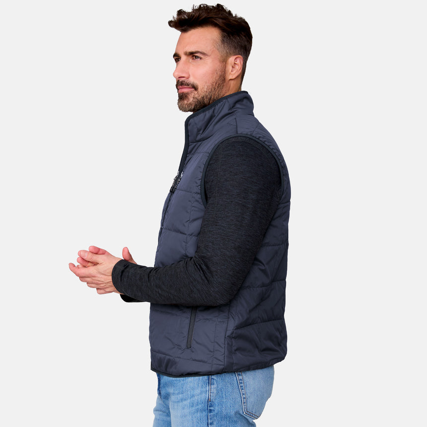 [Justin is 6'1" wearing size M.] Man wearing a dark blue puffer vest on a light gray background