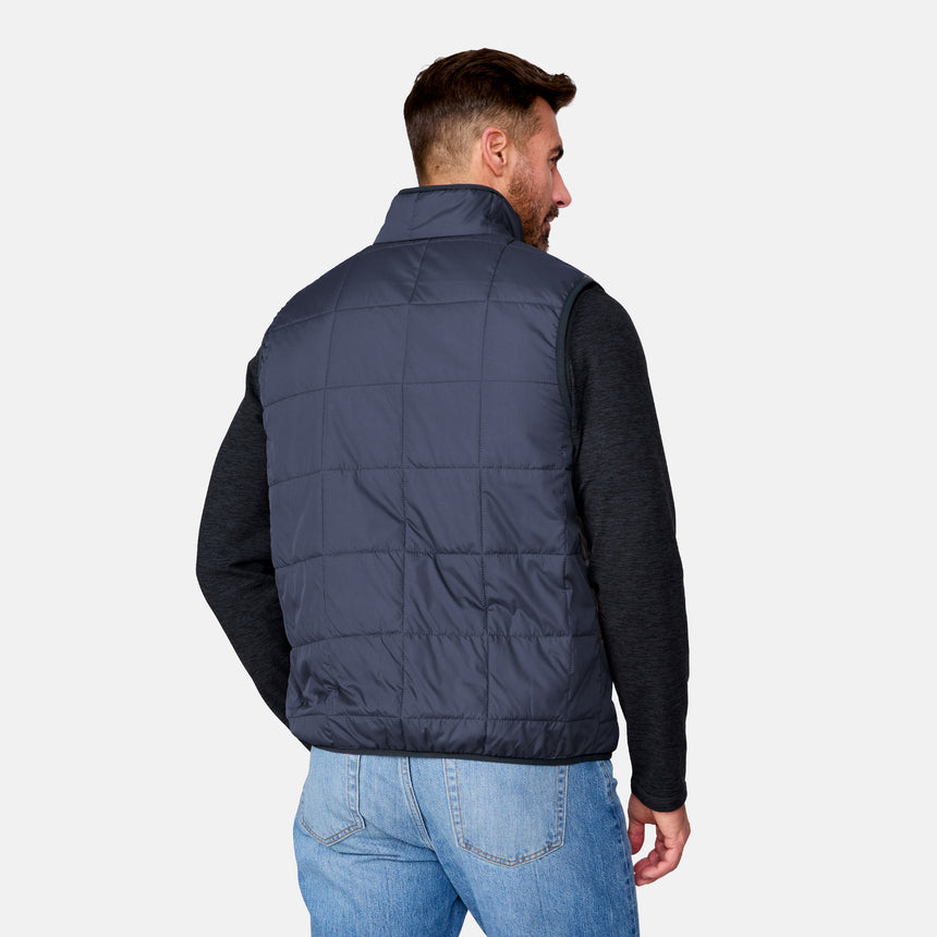 [Justin is 6'1" wearing size M.] Man wearing a navy puffer vest over a black shirt on a white background