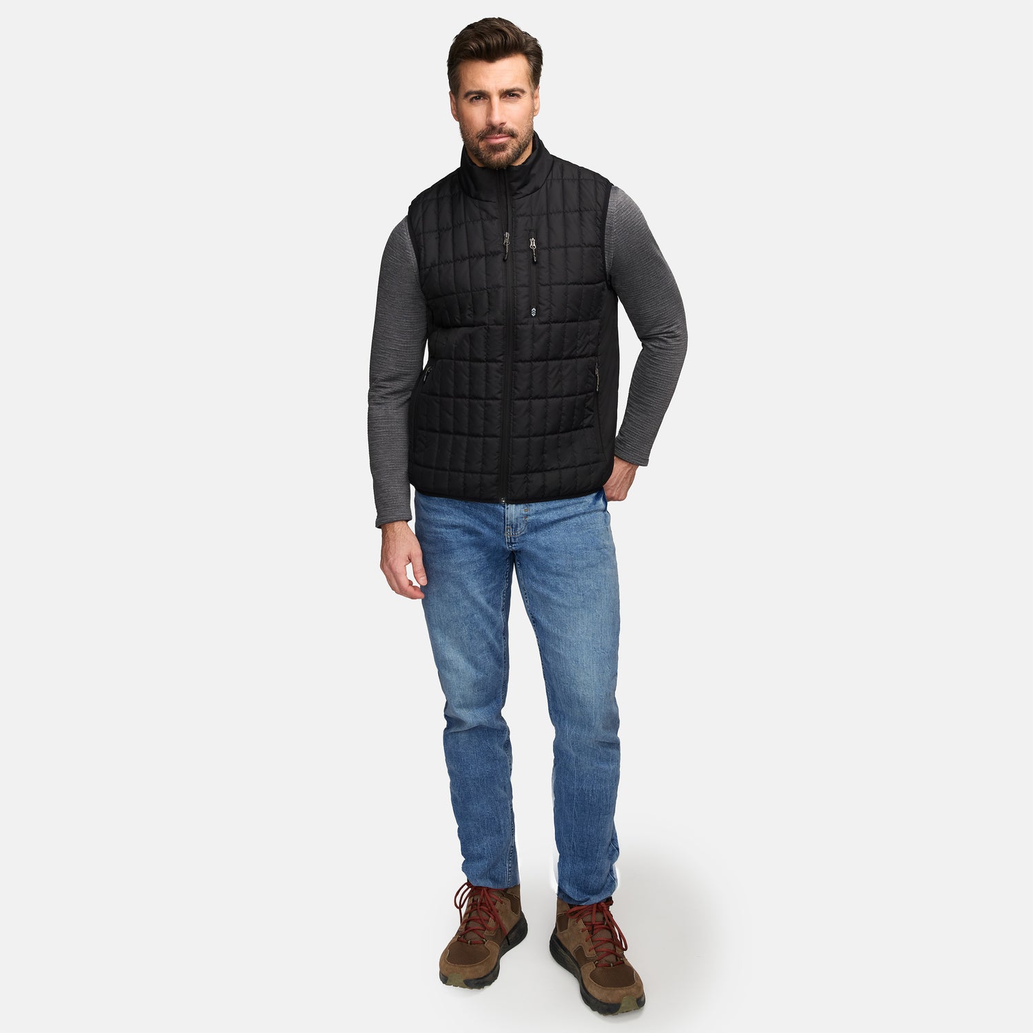 Front view of man in black quilted Sperrin vest with zip pockets and stand collar