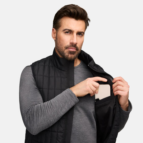 Male model wears black quilted Sperrin full zip puffer vest with stand collar