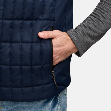 Close up of navy quilted Sperrin vest showing zipper and a hand near the zipper.