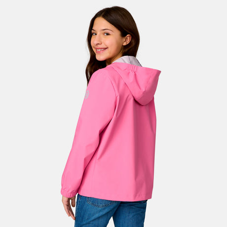 [Model is wearing a size Medium.] Girl wearing the Free Country Girls' Recess X2O Rain Jacket in Rosie, size M, featuring lightweight stretch weatherproof fabric and a full length zipper and attached hood, paired with blue jeans #color_ rosie