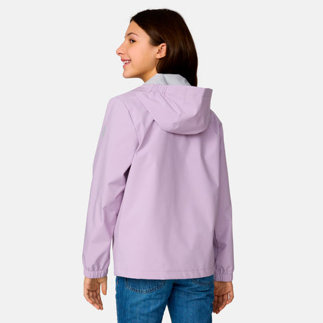 [Model is wearing a size Medium.] Girl wearing the Free Country Girls' Recess X2O Rain Jacket in Wisteria, size M, featuring lightweight stretch weatherproof fabric and a full length zipper and attached hood, paired with blue jeans #color_ wisteria