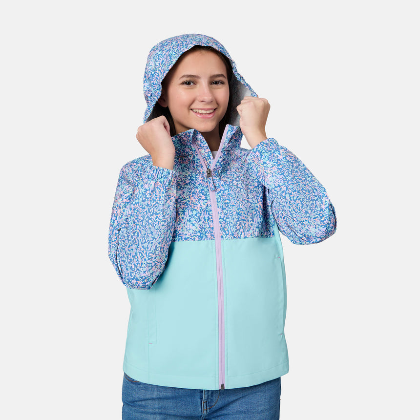 [Kai is wearing size 10-12 M] Child wearing a floral-patterned jacket with a light blue bottom half on a white background