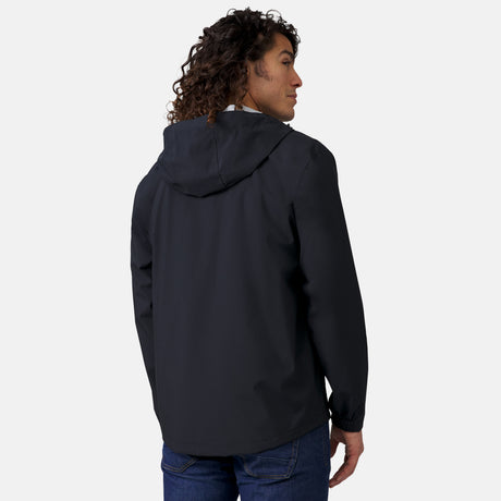 [Jordan is 6’2” wearing a size Medium.] Man wearing Free Country Men's Hydro Lite X2O Spectator Waterproof Jacket in Black, size M, made from lightweight four way stretch performance fabric featuring sealed seams, elastic cuffs, and an attached hood with a drawcord, styled with blue jeans #color_black