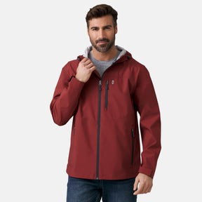 A man with short brown hair and a beard wears the Clearance Men's Hydro Lite X2O Highline Waterproof Jacket in maroon over a gray shirt, standing against a plain light background with one hand touching the collar.
