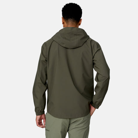 [Josiah is 6'3" wearing a size Medium.] Man wearing Free Country Men's Hydro Lite X2O Spectator Waterproof Jacket in Olive, size M, made from lightweight four way stretch performance fabric featuring sealed seams, elastic cuffs, and an attached hood with a drawcord, styled with green pants #color_olive