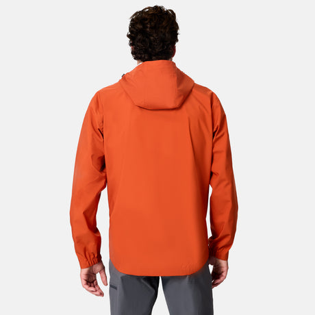 A person with short, curly hair is seen from behind wearing the Free Country Men's Hydro Lite X2O Spectator Waterproof Jacket in orange and gray pants against a plain white background.