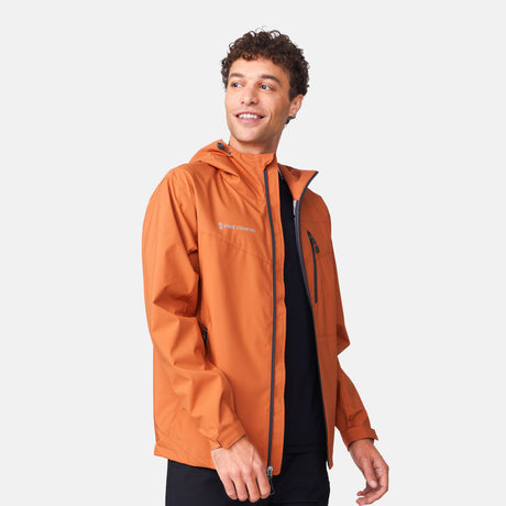 [Miguel is 6'2" wearing a size Medium.] Man wearing Free Country Men's Hydro Lite X2O Status Jacket in Autumn, size M, made from lightweight four way stretch water-resistant performance fabric featuring tab cuffs, an attached hood with a drawcord, and a chest and lower pockets, styled with black pants #color_autumn