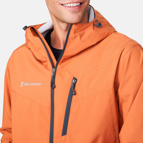 [Miguel is 6'2" wearing a size Medium.] Man wearing Free Country Men's Hydro Lite X2O Status Jacket in Autumn, size M, made from lightweight four way stretch water-resistant performance fabric featuring tab cuffs, an attached hood with a drawcord, and a chest and lower pockets, styled with black pants #color_autumn