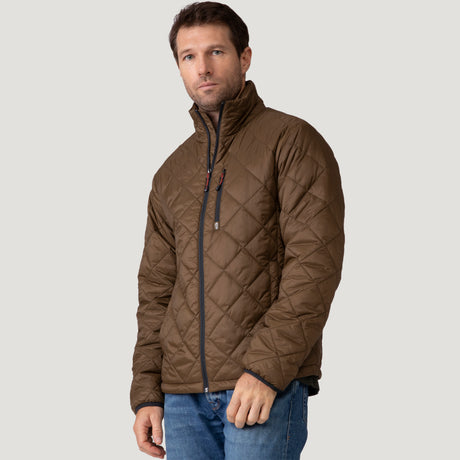 [Vince is 6'1" wearing a size Medium.] Man wearing the Free Country Men's Apex Quilted Puffer Jacket in brown, layered over a grey shirt and jeans, standing against a light background.