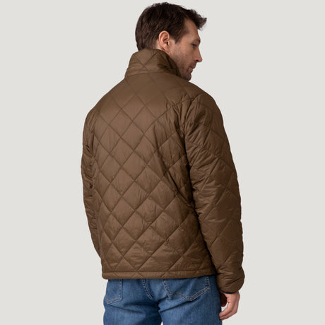[Vince is 6'1" wearing a size Medium.] Man wearing the Free Country Men's Apex Quilted Puffer Jacket in brown, layered over a grey shirt and jeans, standing against a light background.