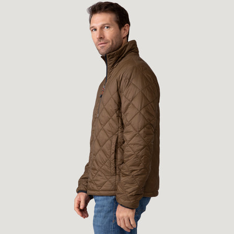 [Vince is 6'1" wearing a size Medium.] Man wearing the Free Country Men's Apex Quilted Puffer Jacket in brown, layered over a grey shirt and jeans, standing against a light background.
