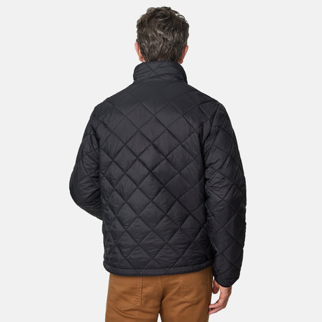 [Kolby is 6'2" wearing size M] Model wearing a black quilted Free Country jacket with diamond-pattern stitching, high stand collar, and zippered chest pocket; paired with brown pants and a blue crewneck tee for a warm, transitional-weather look.