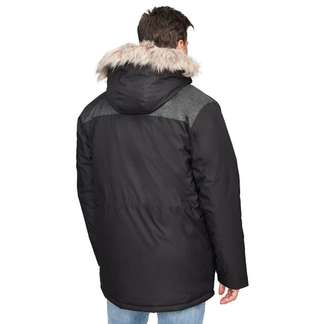 A man wearing the Clearance Men's Momentum II Midweight Parka Jacket, featuring poly-fill insulation, a detachable faux fur hood, a black body with a dark gray upper back panel, stands facing away from the camera in light blue jeans.