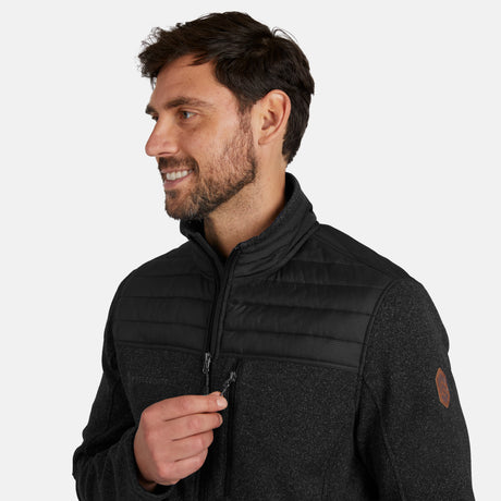 [Model is wearing size M.] Man wearing Free Country Men's Frore Knit Fleece Jacket in black with a full zip front, zipper chest pocket, light grey background. Perfect men’s jacket for fall weather.