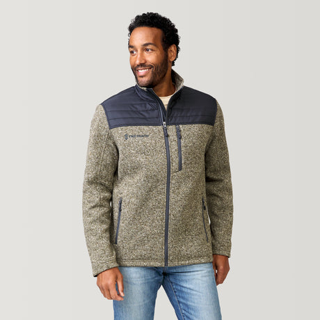 Man wearing a two-tone khaki fleece jacket with a gray background