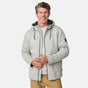 [Kolby is 6’2” wearing a size Medium.] Man wearing the Free Country Men's Northwood Mountain Fleece Hoodie in light gray with black drawstrings, standing with hands in pockets against a plain, light background.