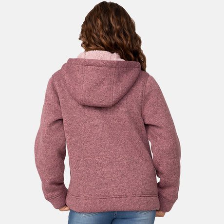 [Model is wearing size M.] Girl wearing the Free Country Girls' Mountain Fleece Jacket in textured pink, layered over a white shirt and blue jeans, smiling in a neutral-colored indoor setting.
