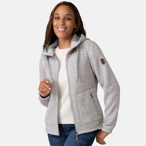 [Shelby is 5'9" wearing a size Small.] Woman wearing Free Country Women's Mountain Fleece Jacket in grey with a full front zipper opening, soft lining, lower pockets, an attached hood with an adjustable drawcord, light grey background. Best women’s jacket for fall weather.