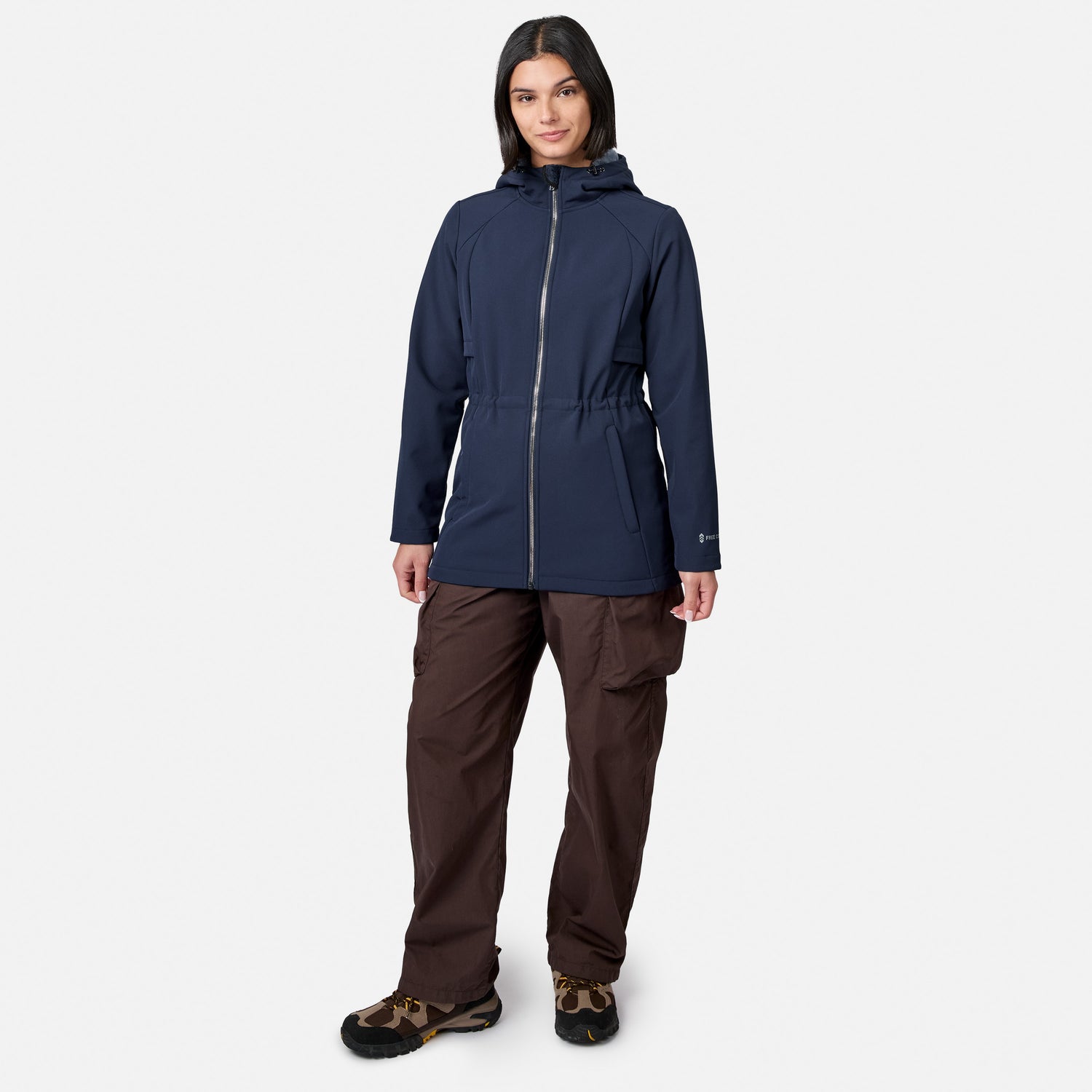 [Model is wearing size S.] A woman modeling a dark navy hooded jacket with a silver zipper, paired with brown pants and hiking boots, against a light gray background.