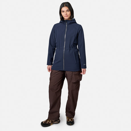 [Model is wearing size S.] A woman modeling a dark navy hooded jacket with a silver zipper, paired with brown pants and hiking boots, against a light gray background.