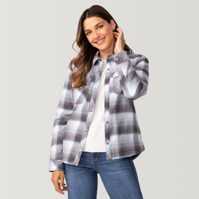 [Olga is 5’9" wearing a size Small.] Woman wearing Free Country Women's Koshi Adirondack Flannel Shirt Jacket in grey and white plaid with a full front button opening, soft lining, chest pockets, light grey background. Best women’s jacket for winter weather.