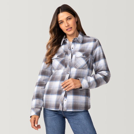 [Olga is 5’9" wearing a size Small.] Woman wearing Free Country Women's Koshi Adirondack Flannel Shirt Jacket in grey and white plaid with a full front button opening, soft lining, chest pockets, light grey background. Best women’s jacket for winter weather.