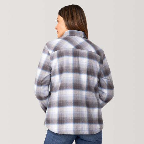 [Olga is 5’9" wearing a size Small.] Woman wearing Free Country Women's Koshi Adirondack Flannel Shirt Jacket in grey and white plaid with a full front button opening, soft lining, chest pockets, light grey background. Best women’s jacket for winter weather.