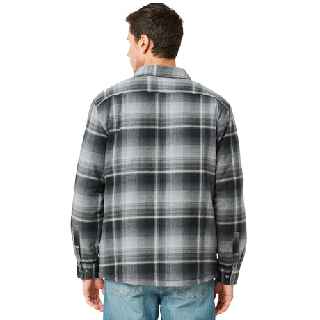 A man faces away in the Clearance Men's FreeCycle® Utility Work Shirt—black and gray plaid, made with eco-conscious REPREVE—paired with light blue jeans, standing against a plain white background.